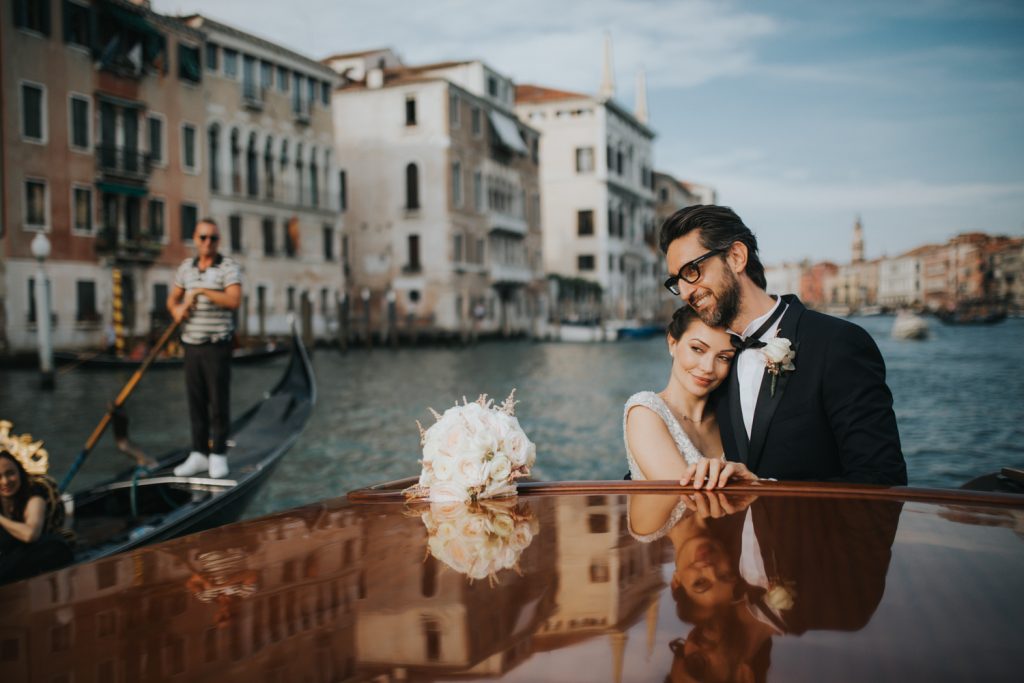 Venice wedding photographer, newly weds on water taxi on Grand Canal
